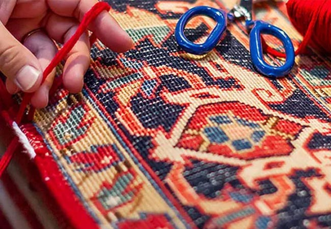 Worker repairing damaged rug