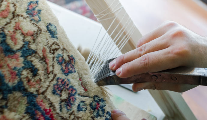 rug repairing by worker