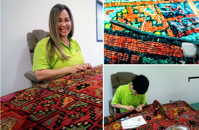 Women and boy repairing a damaged rug