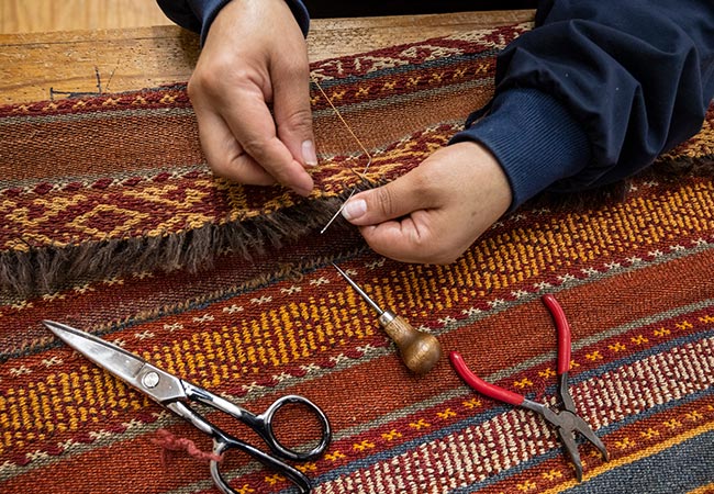 Workers repairing the rug